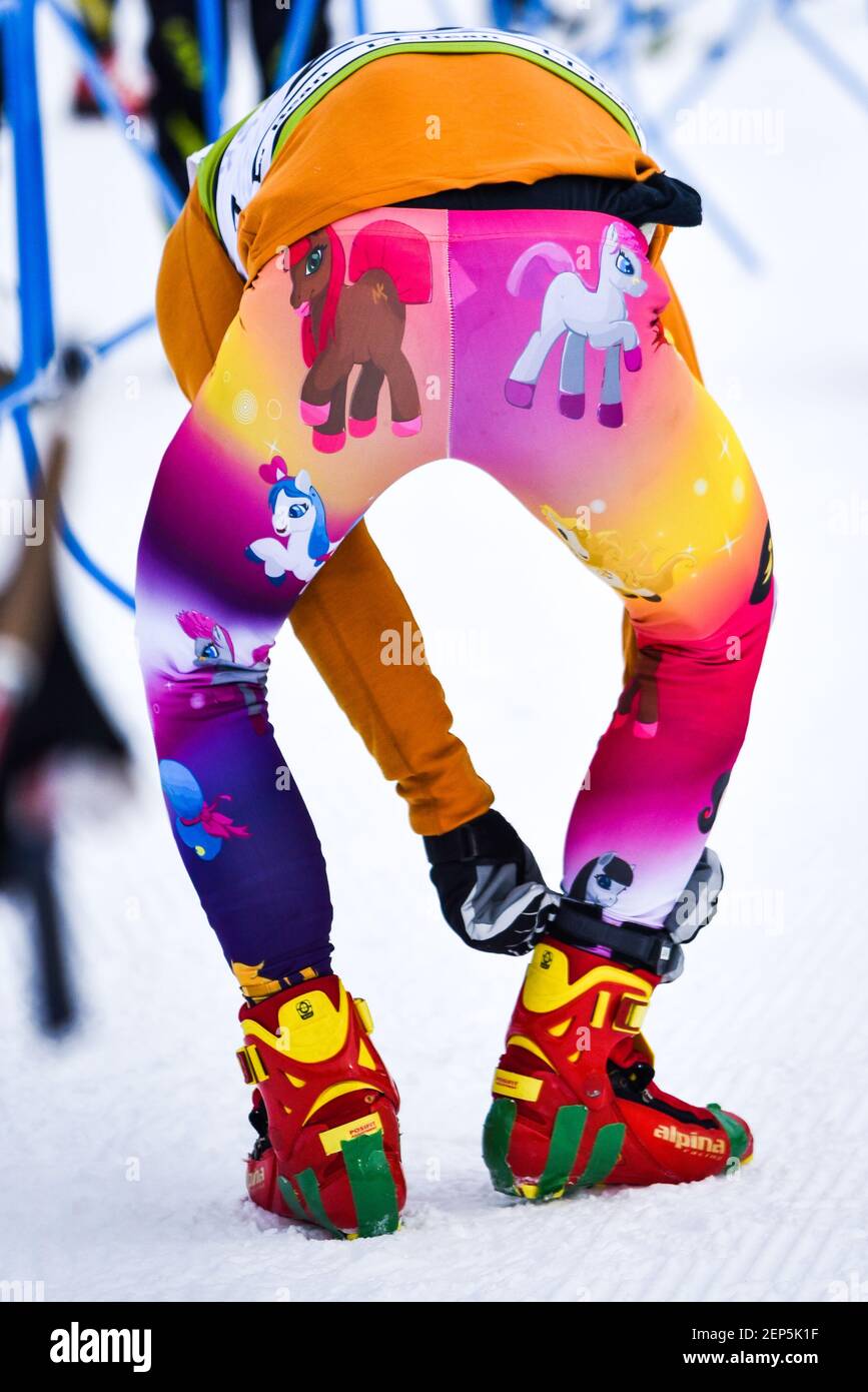 Cross country ski racer in striking My Little Pony tights adjusts equipment before the start of a race, Craftsbury Outdoor Center, VT, USA. Stock Photo
