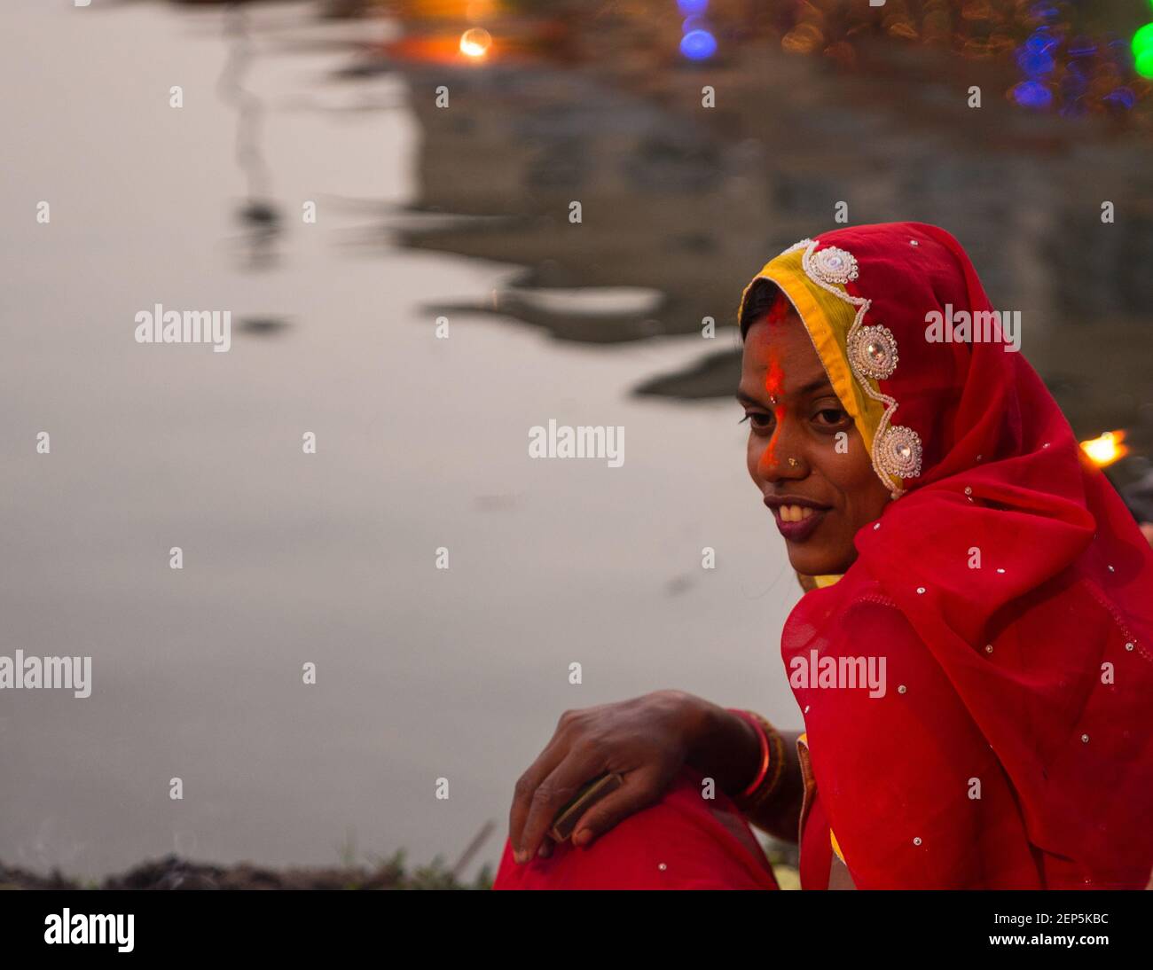 A devotee waits to perform the rituals during the festival. The Chhath ...