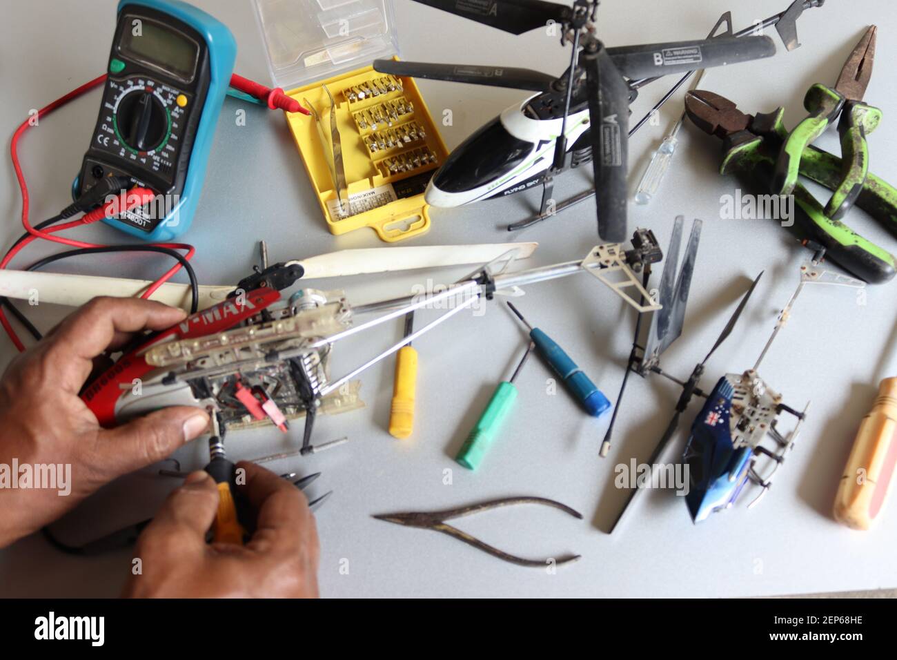 Tried to start to repair my son's broken three RC helicopters during the pandemic. Stock Photo
