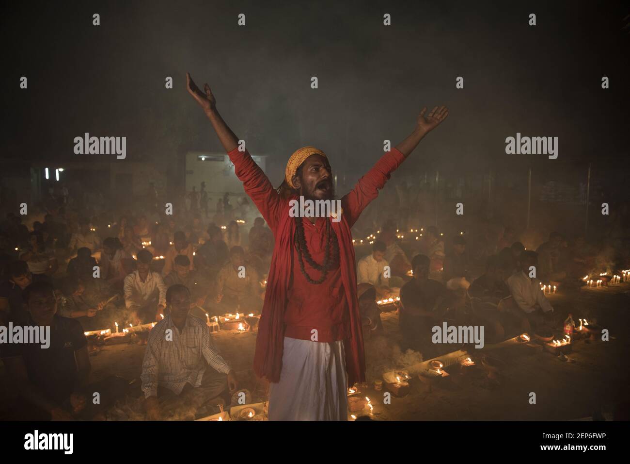 Hindu Devotees Sit On The Floor To Worship With Prodip And Candle Lights Pray To God In Front Of Shri Shri Lokanath Brahmachar Ashram And During Their Fasting Program Called Kartik Brati