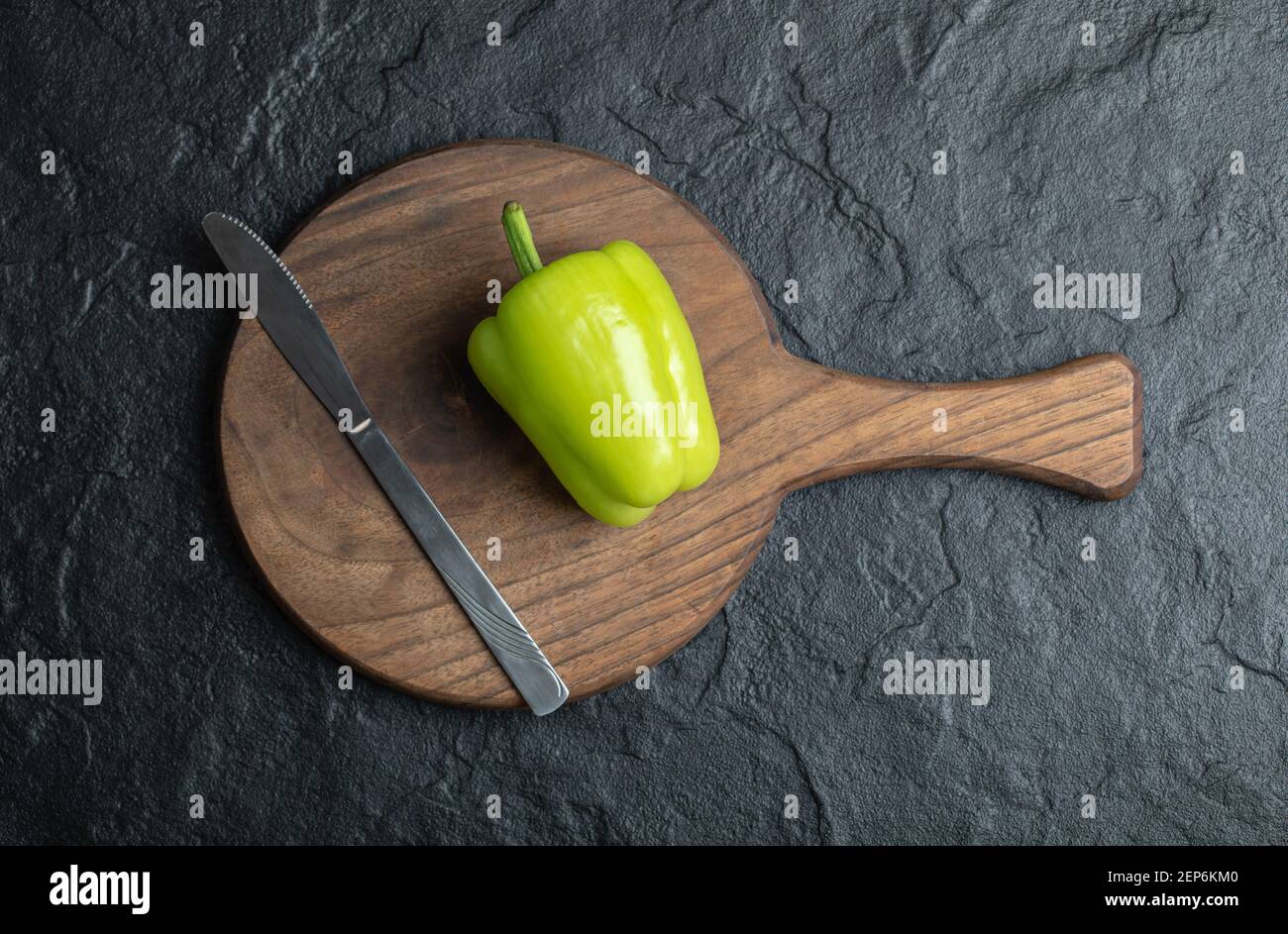 Top view of green pepper on wooden chopping board with knife Stock ...