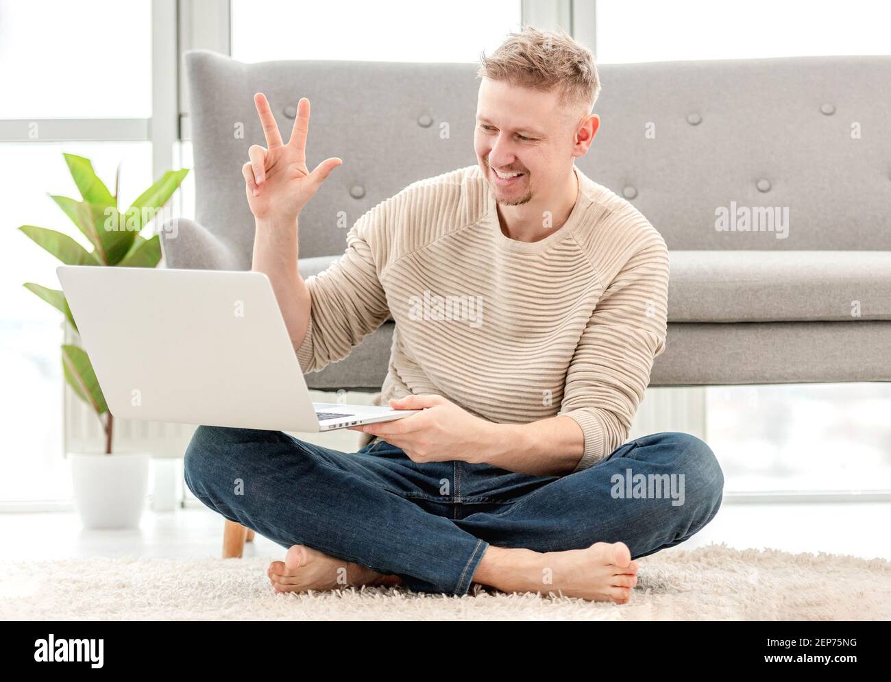Man talking online using webcam on laptop Stock Photo