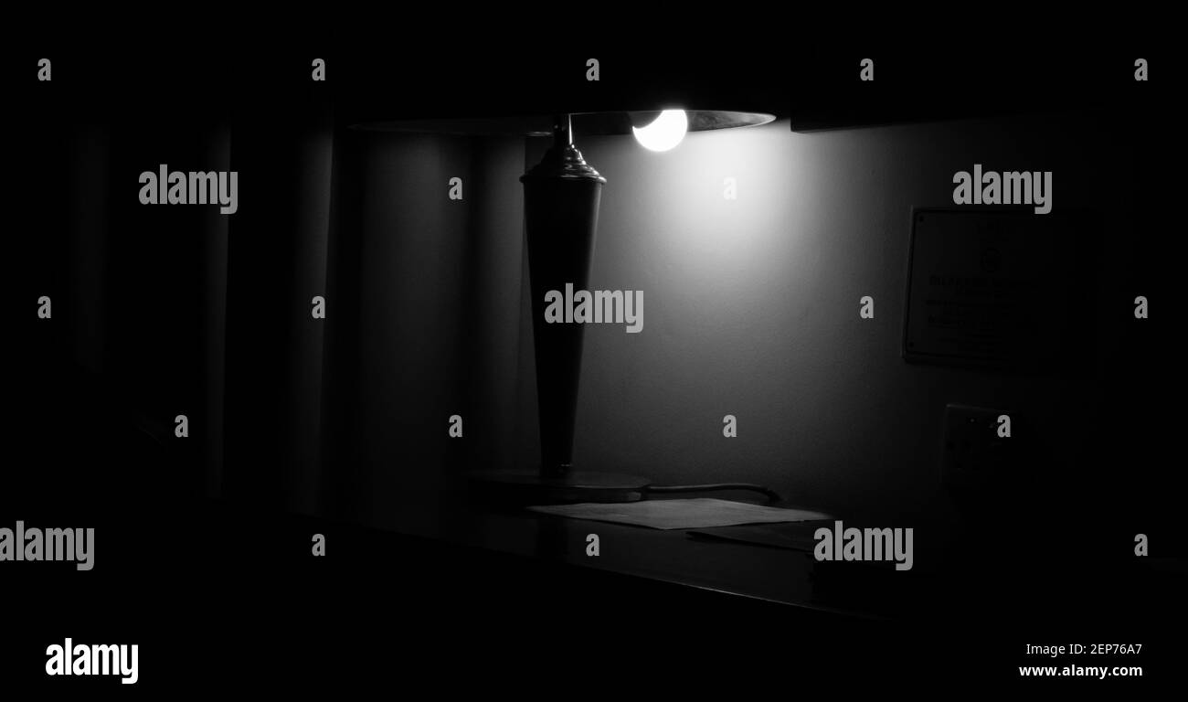 A dramatic image for a lamp lightning up the room in the middle of the dark night. Stock Photo