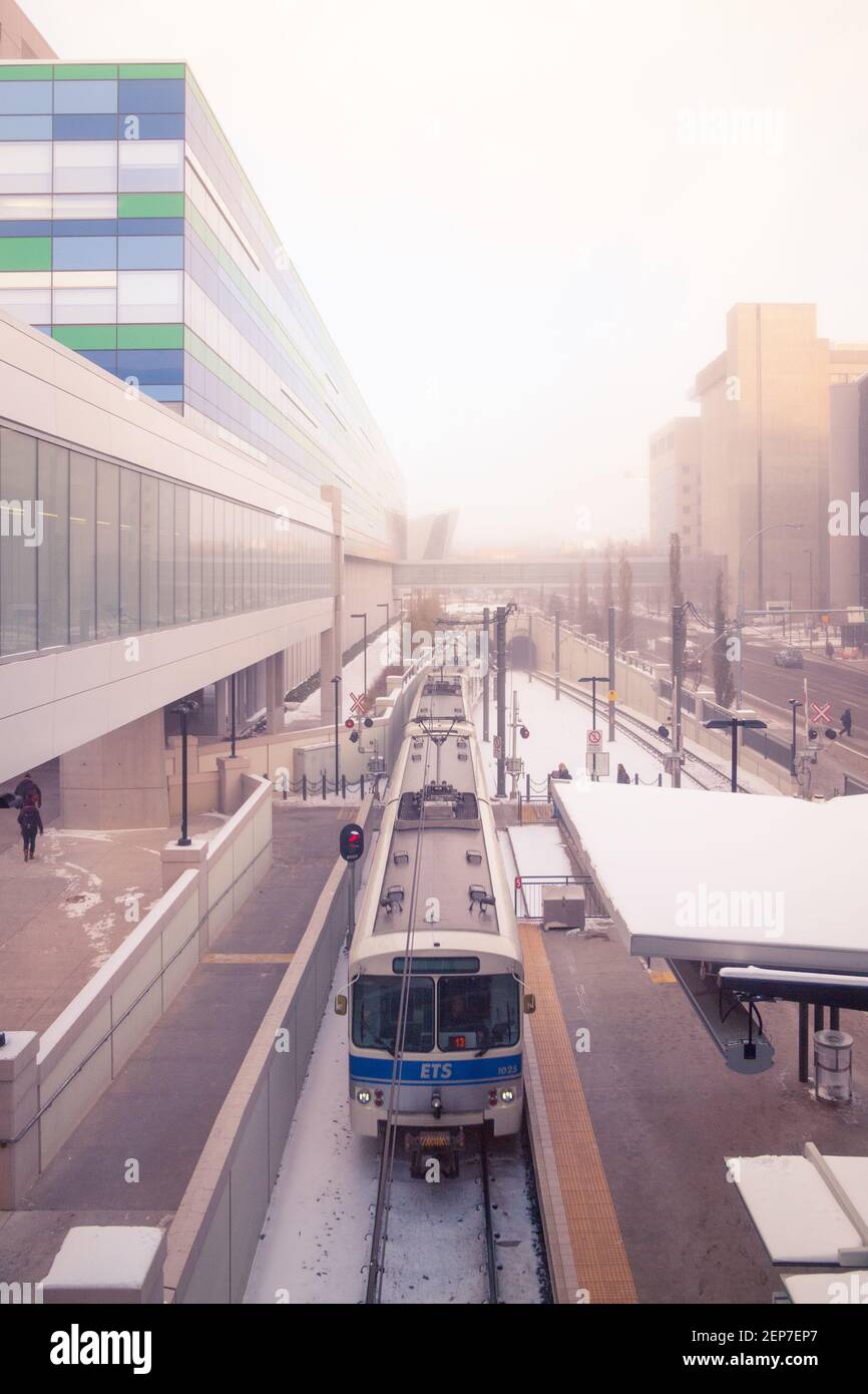 An Edmonton Transit System (ETS) LRT train at Health Sciences Station in front of the Edmonton Clinic Health Academy in Edmonton, Canada. Stock Photo
