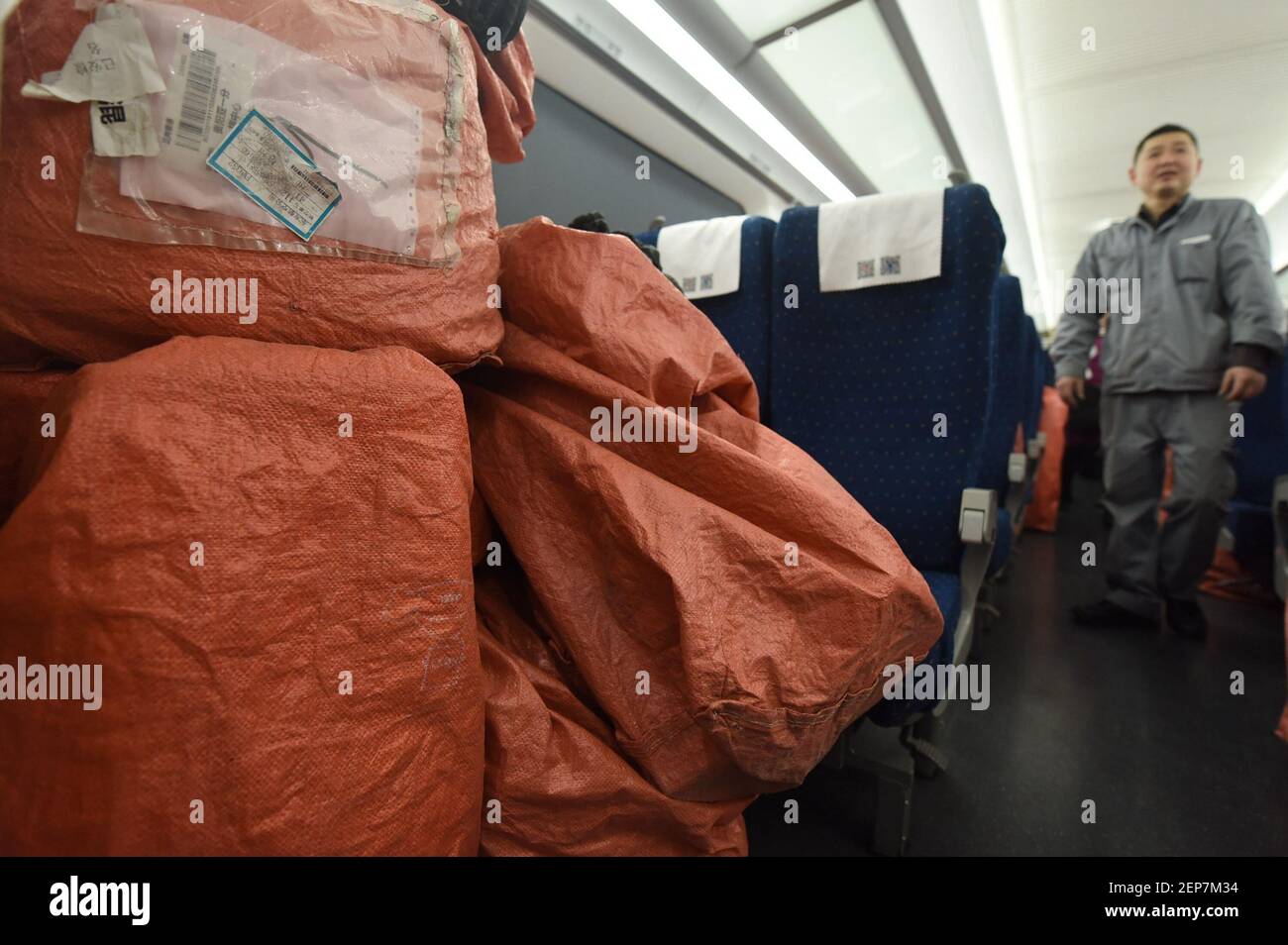 Railway workers deliver express packages purchased online by netizens on â€œ double 11 â€to the Hangzhou-Guiyang high-speed train G1331 at Hangzhou east railway station , zhejiang, Nov. 11, 2019. It is reported that during the 10-day 'double 11' railway e-commerce golden week this year, the railway department will give full play to the advantages of high-speed rail network, scientifically use high-speed trains to carry passengers, confirm trains, luggage carts and other transport capacity resources, to provide express railway transportation services for customers and ensure that online shopp Stock Photo