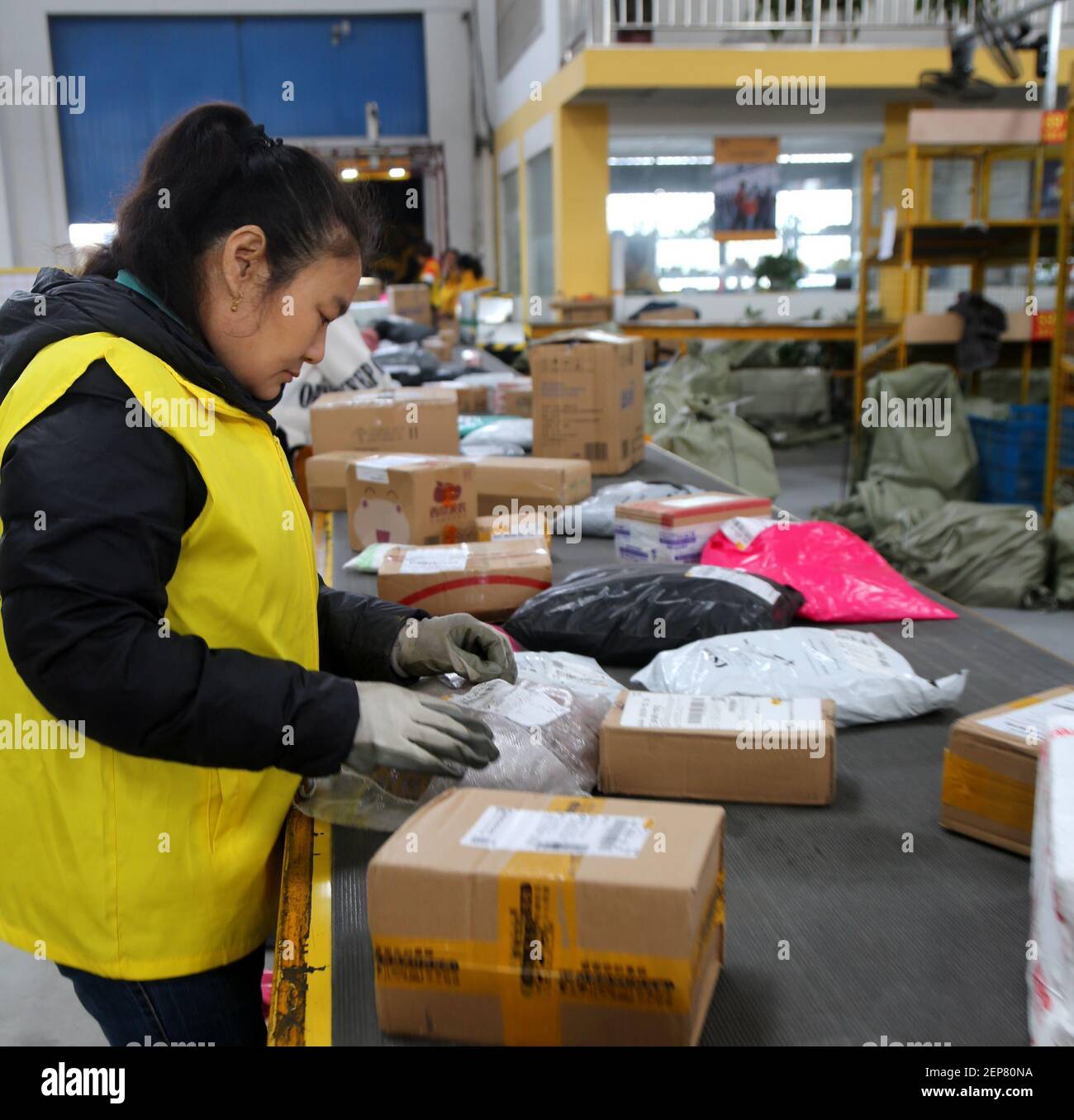 Workers at a logistics center sort out parcels as Double 11 delivery ...