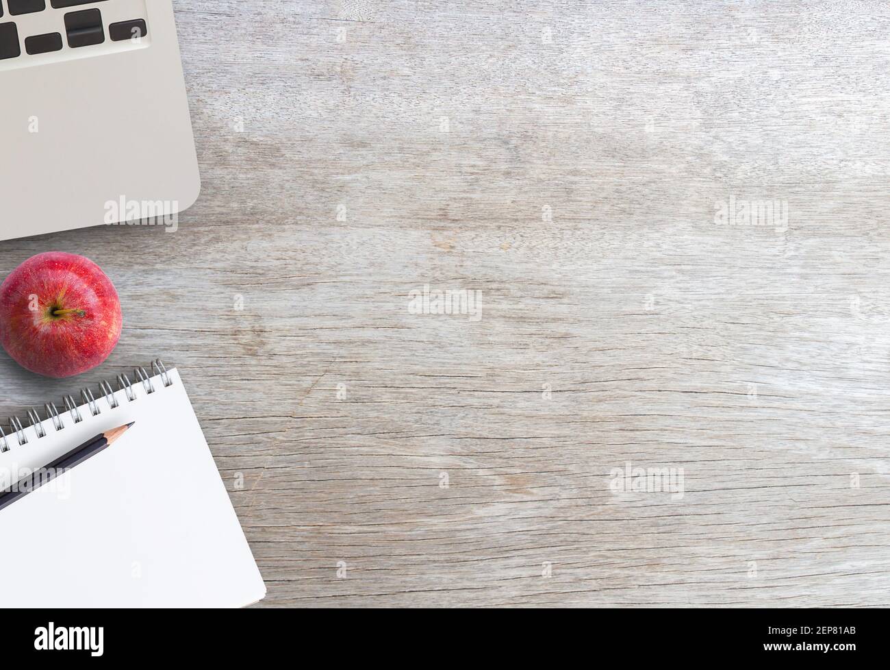 Top view of laptop computer blank notepad with empty pages, pencil and