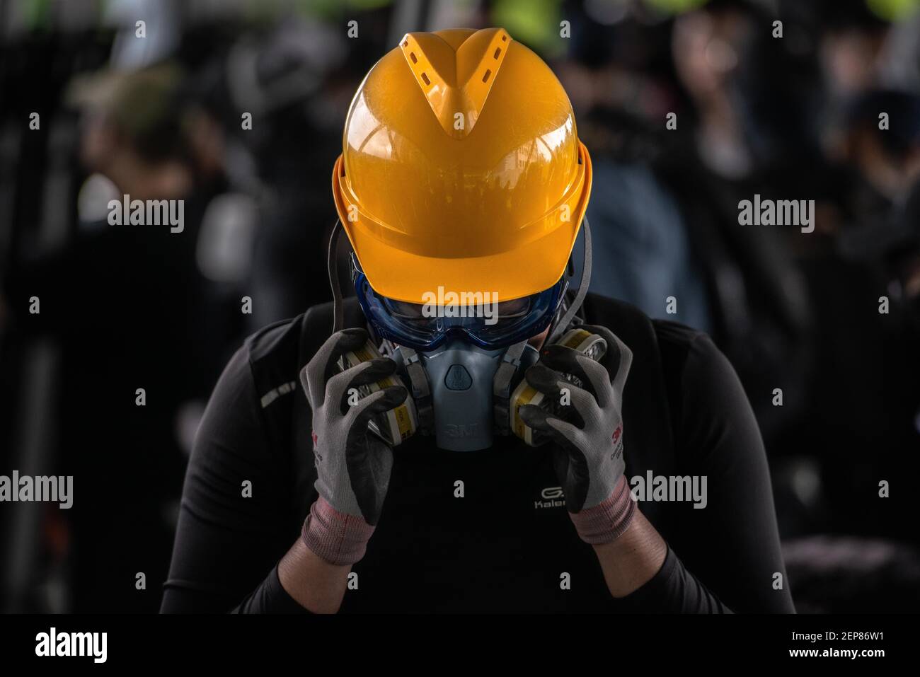 A protester adjust his respirator mask during the demonstration ...