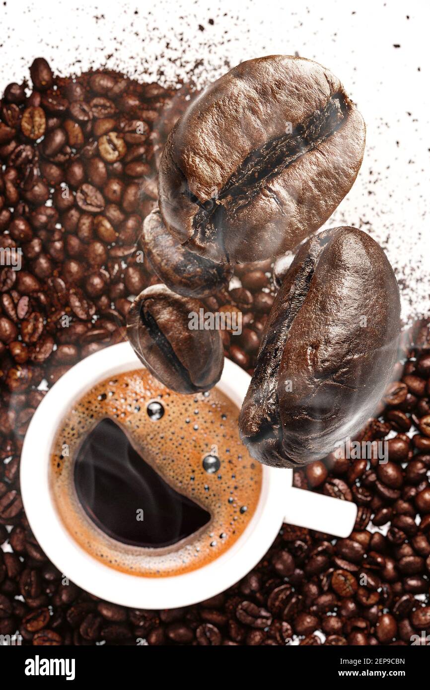Coffee Beans Fall In A Cup With Coffee Stock Photo Alamy coffee-beans-fall-in-a-cup-with-coffee-stock-photo-alamy