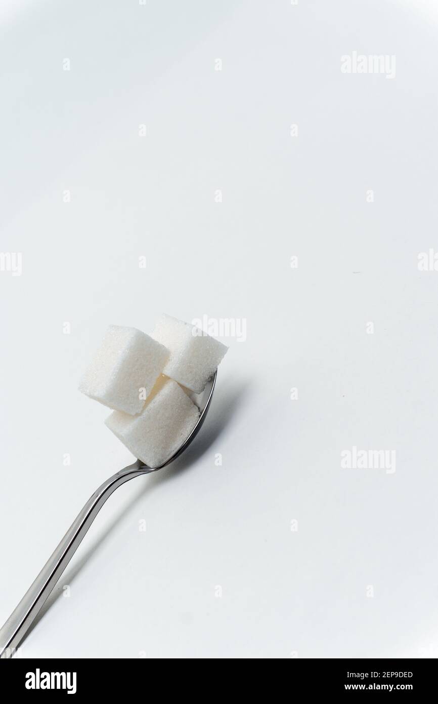 sugar cubes in a teaspoon sweets calorie ingredient Glucose Stock Photo