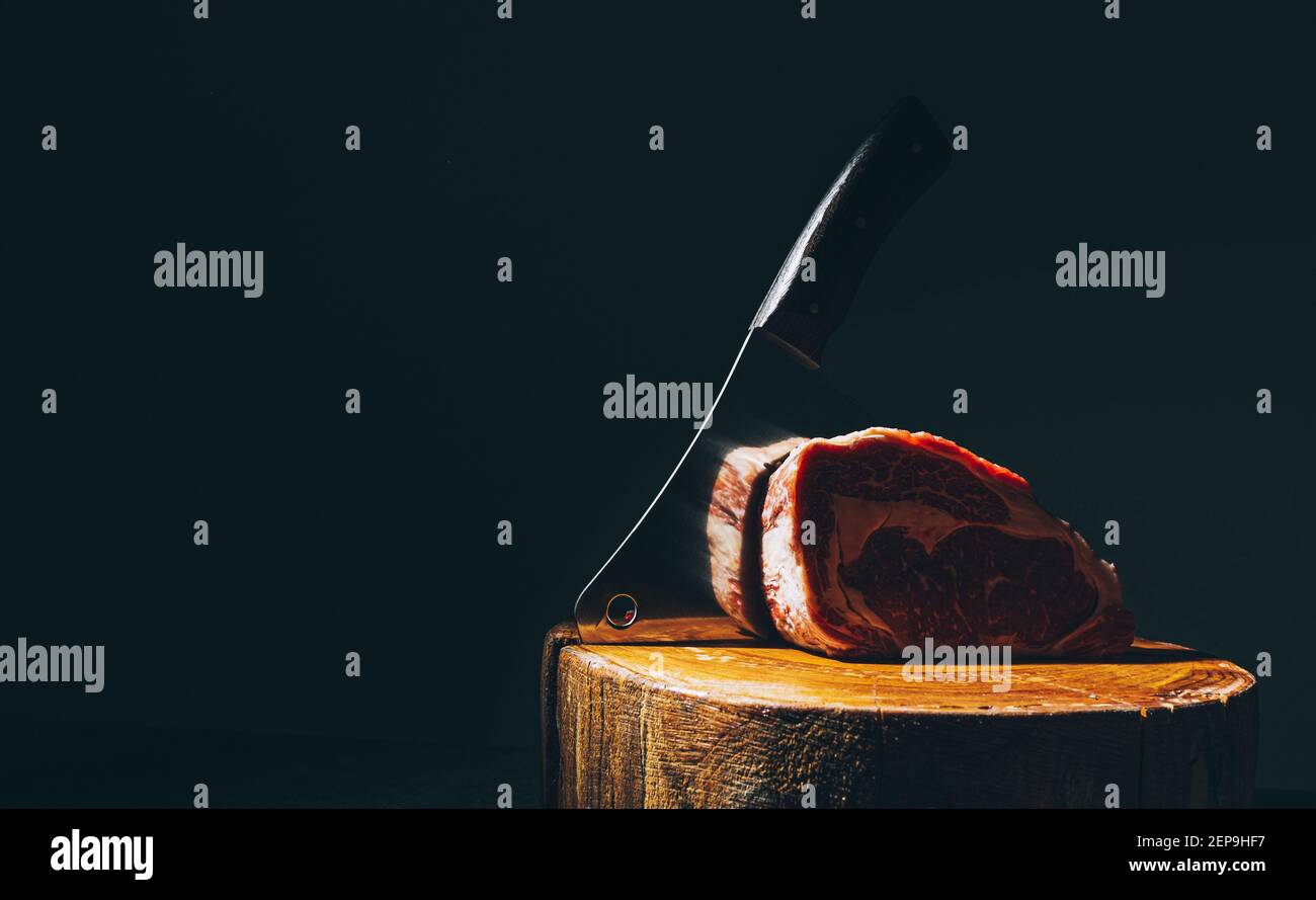 butcher knife and meat on a cutting board Stock Photo Alamy