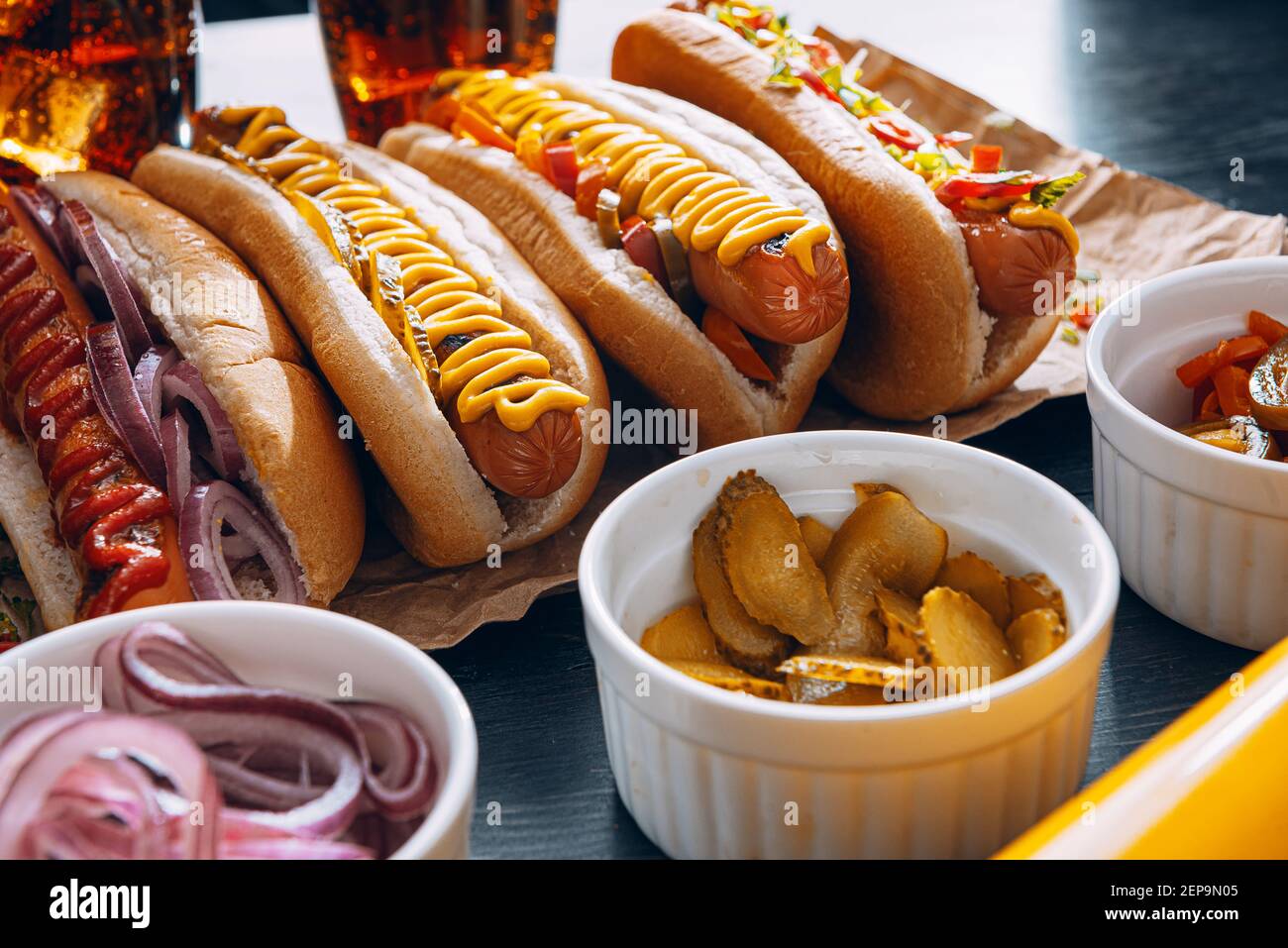 American hot dog with ingredients on a dark wooden background Stock
