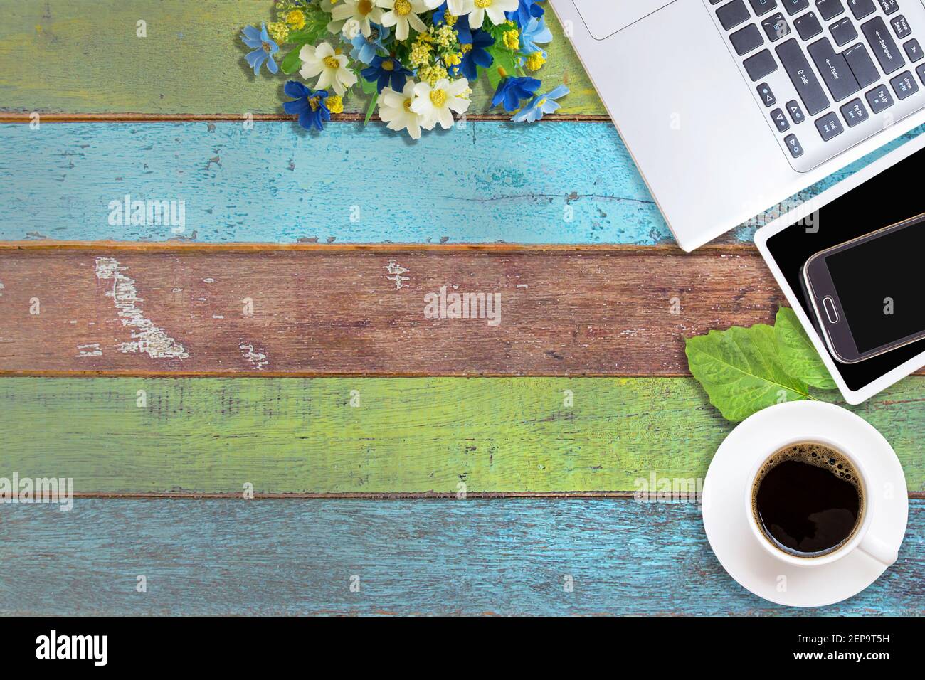 Office desk table with laptop computer, coffee cup and smart phone. Top