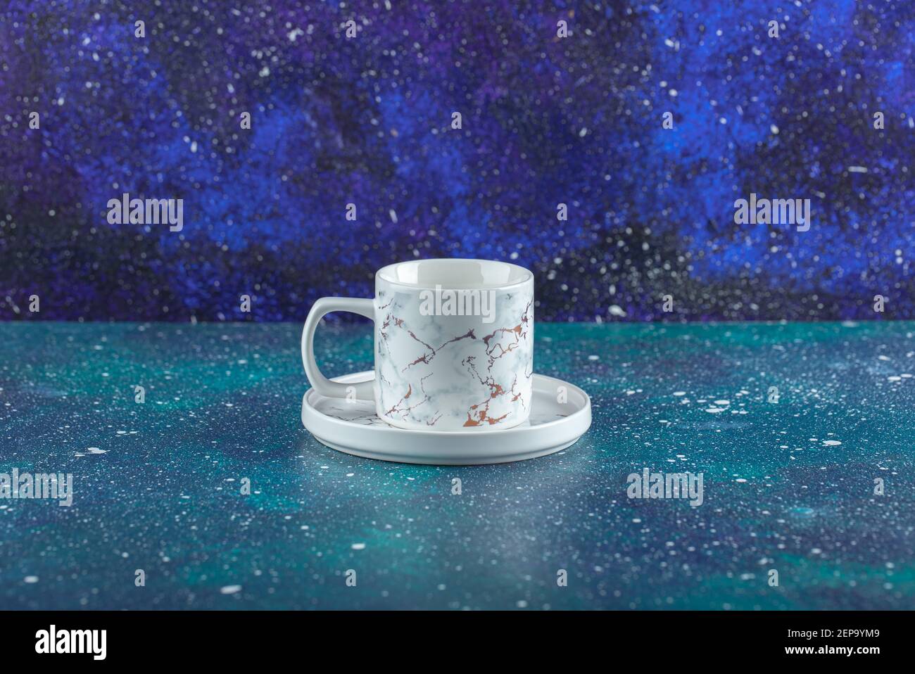 White porcelain cup on blue background Stock Photo