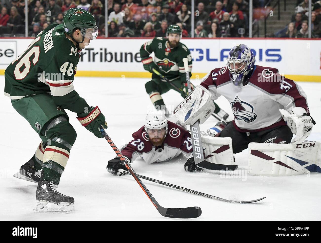 The Minnesota Wild's Jared Spurgeon (46) looks for a shooting opportunity against Colorado Avalanche goaltender Philipp Grubauer (31) as defenseman Ian Cole (28) hits the ice in the first period on Thursday, Nov. 21, 2019, at the Xcel Energy Center in St. Paul, Minn. (Aaron Lavinsky/Minneapolis Star Tribune/TNS) Stock Photo