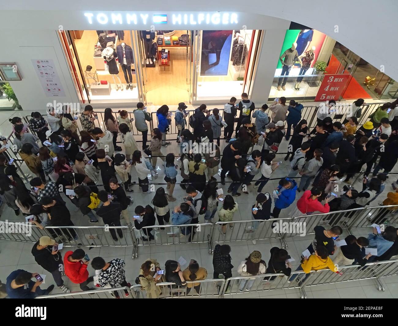Local citizens, especially the youth, form a long line to buy milk tea