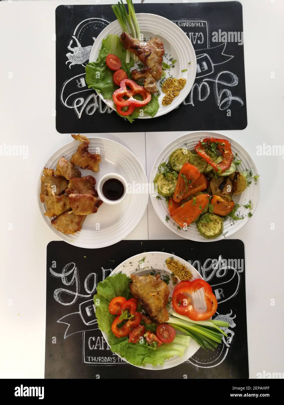 Steak of fresh fried meat and fresh vegetables on the dining table for