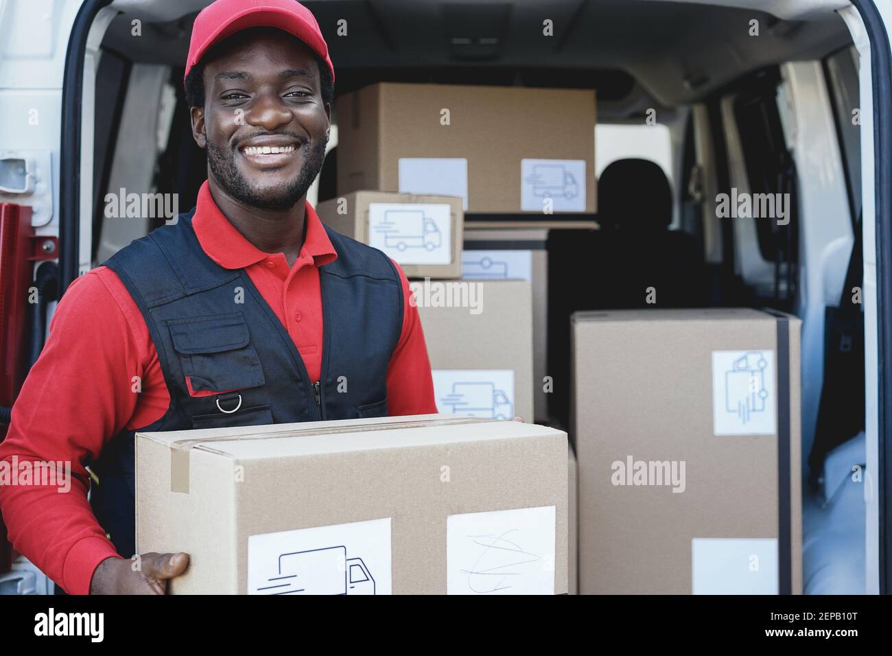 Delivery guy, transport and black man writing on paper outdoor for shipping  or courier service. Happy african person or driver with cardboard boxes or  package form at van from commercial supplier Stock