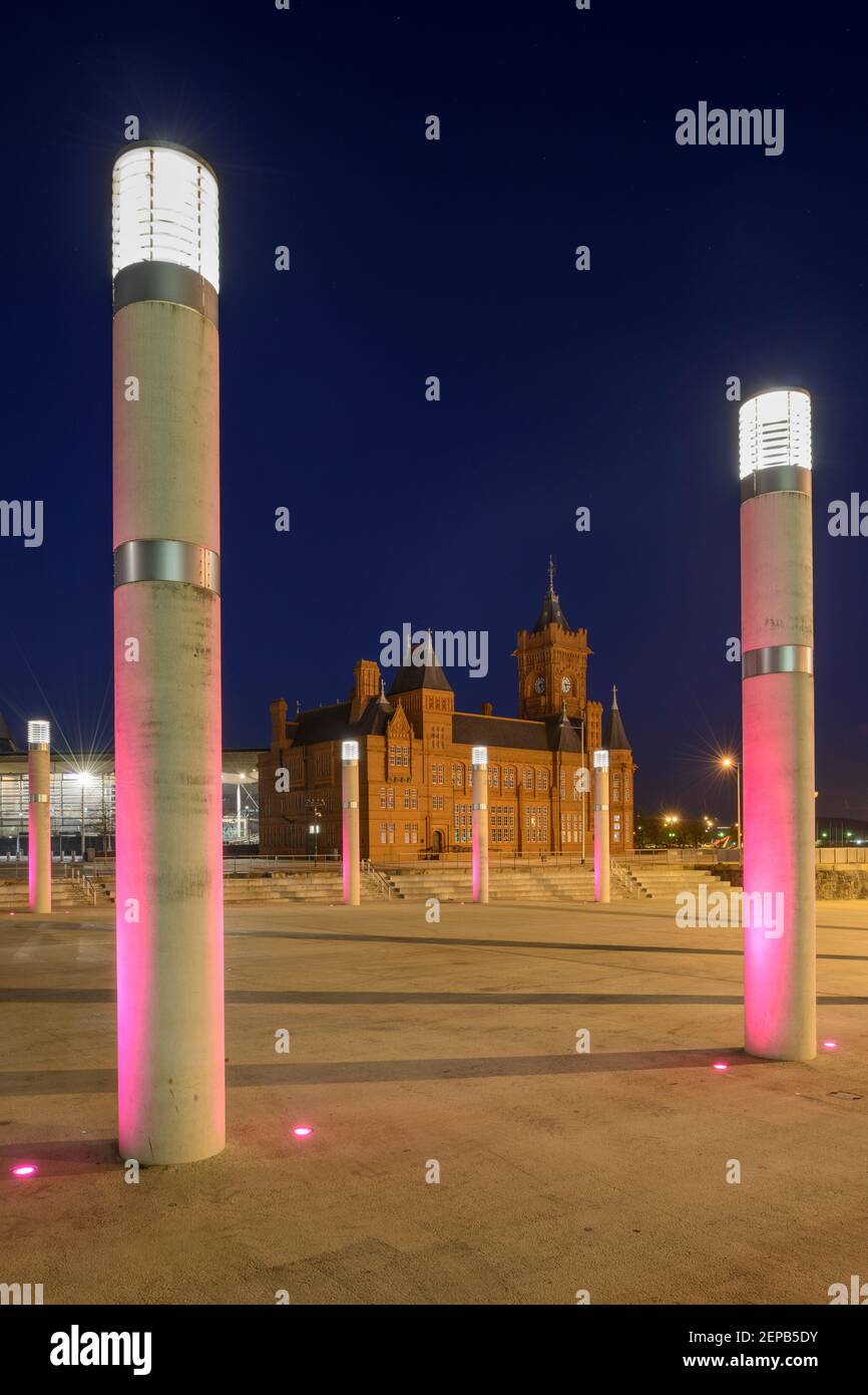 The Pierhead Building and surrounding floodlit pillars at Cardiff Bay, Wales. Stock Photo