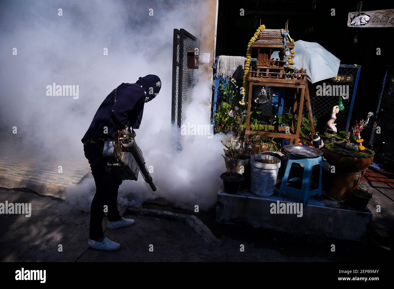 Man spray fogging to eliminate mosquitoes that cause dengue hemorrhagic