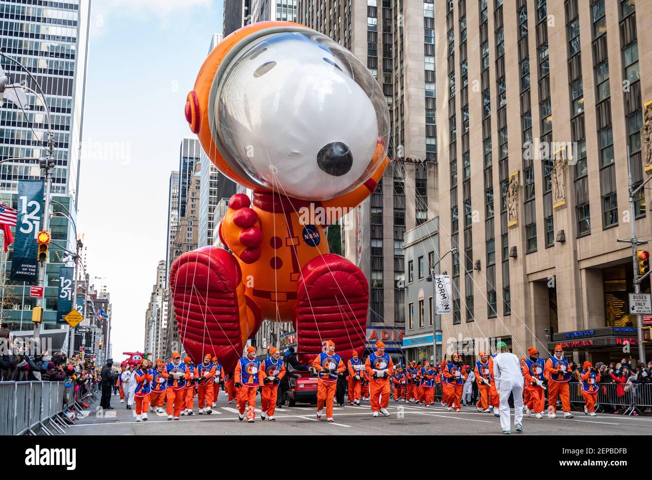 Snoopy floats along 6th Avenue as thousands of spectators celebrate the ...