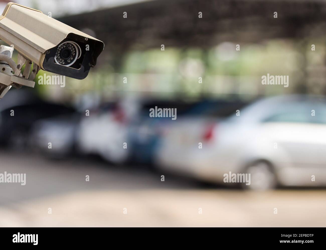 Image of CCTV security camera on blur car parking background Stock
