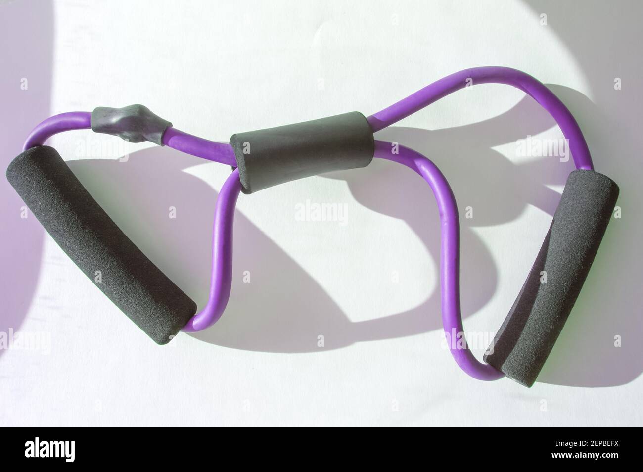 Back in action Modern rubber chest expander on white background Stock