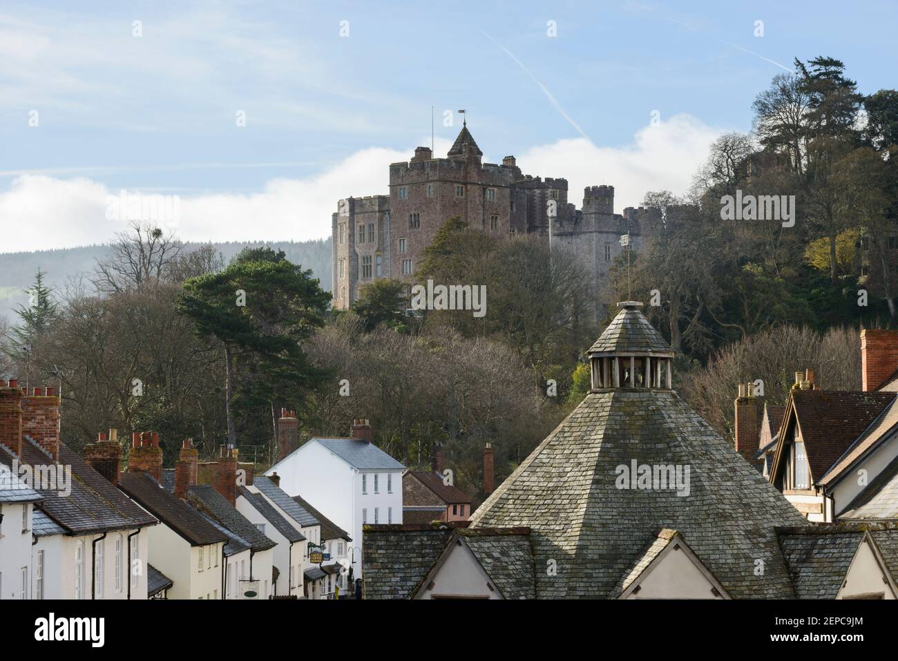 The roof of Dunster's Yarn Market with the castle in the background. Dunster, Somerset, UK. Stock Photo