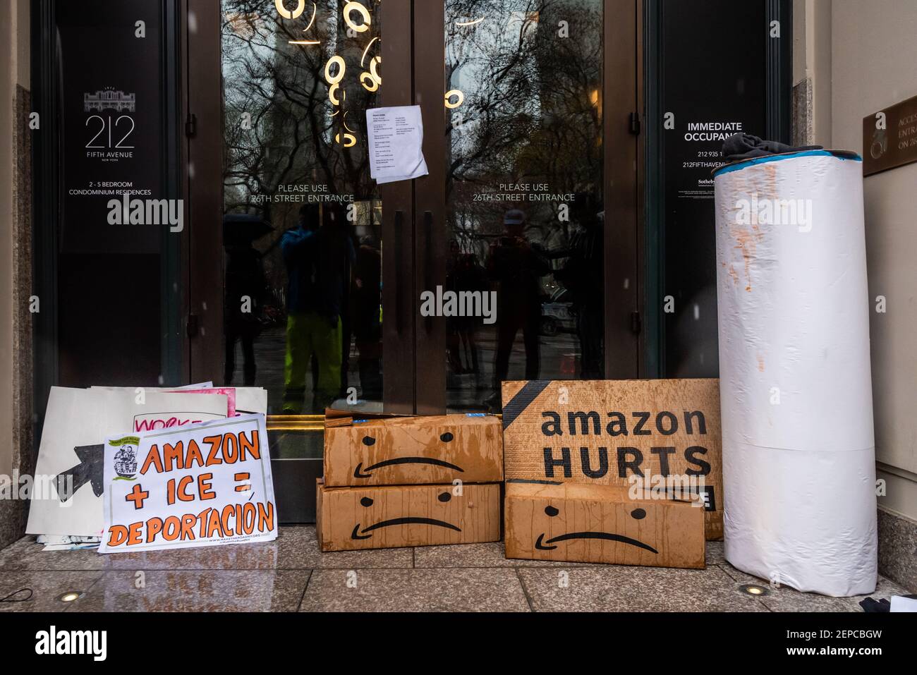 Sad Bezos Demonstrators leave boxes with sad faces and protest signs outside Jeff ...
