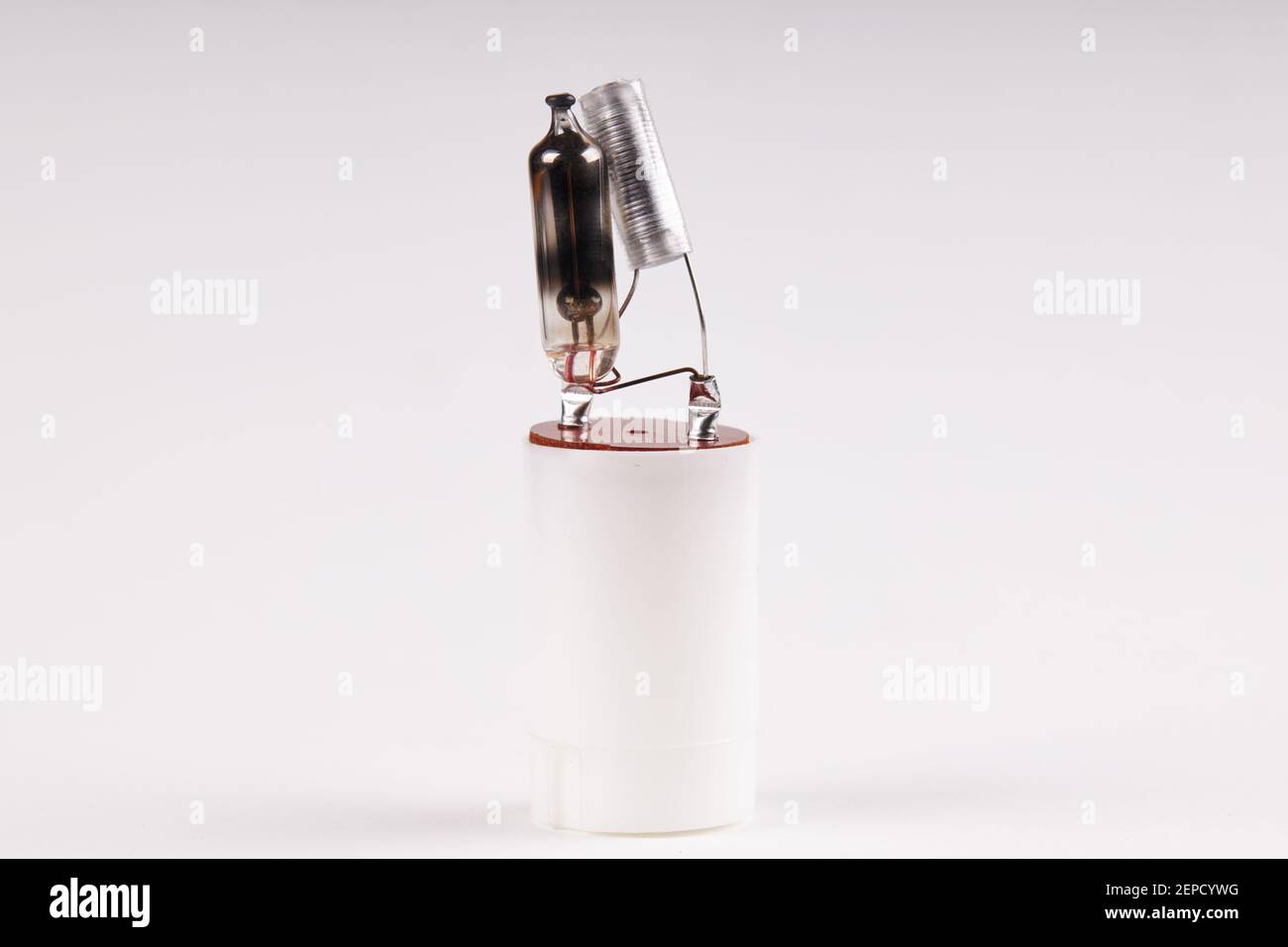 broken fluorescent light starter. lighting equipment. over white