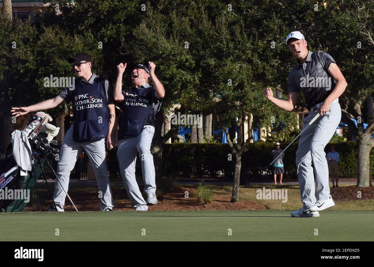 Jason Langer (right) and his team's caddies react after Langer sunk the  winning putt at the PNC Father Son Challenge golf tournament at The  Ritz-Carlton Golf Club in Orlando. Langer played with