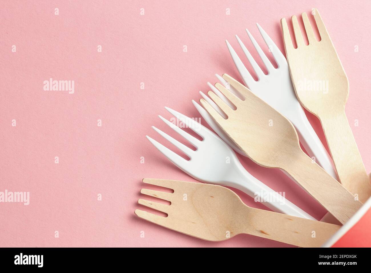 wooden and plastic forks at paper and plastic cup. ecofriendly and