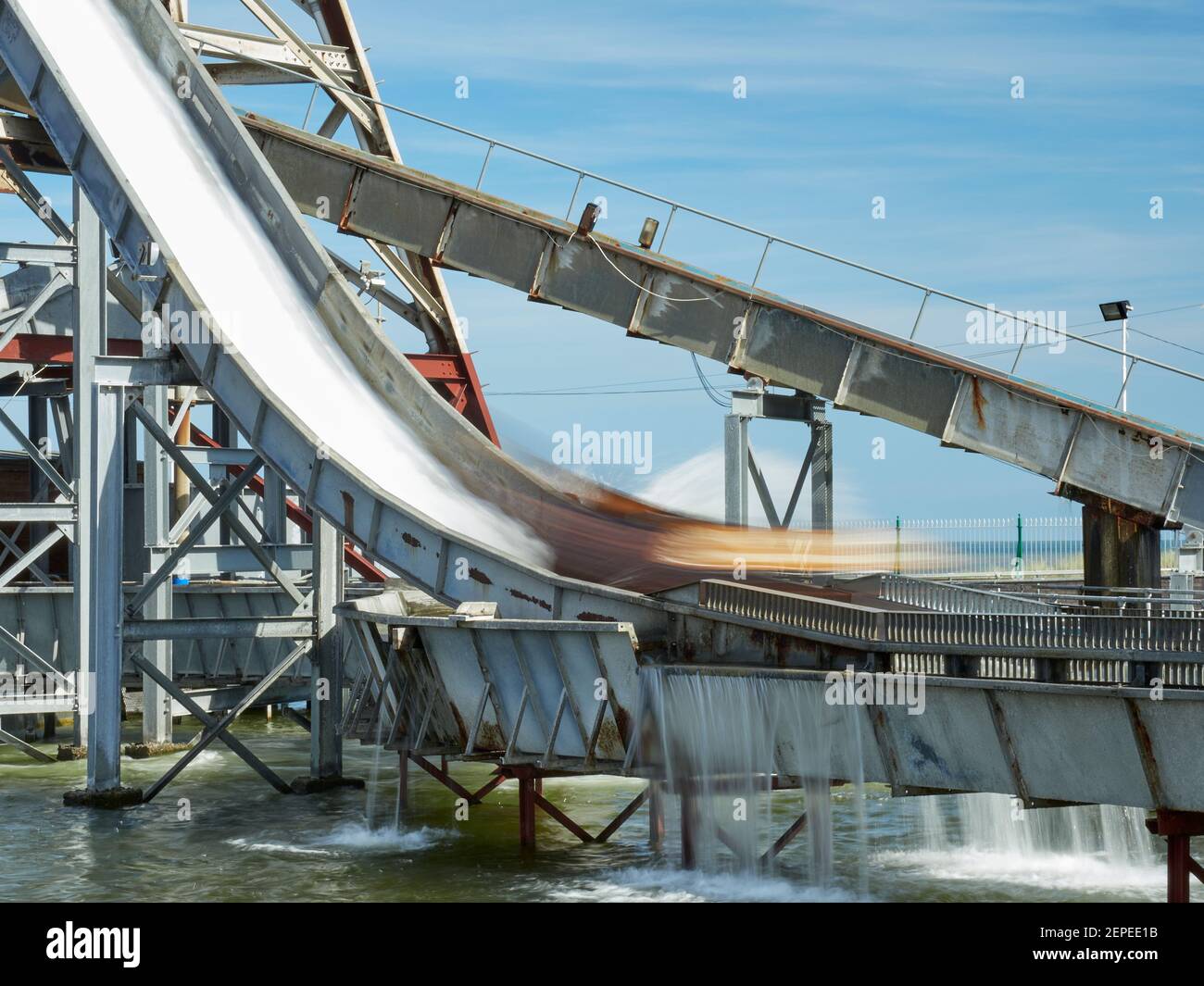 Long exposure of highest drop on Log Flume ride Pleasure beach Great Yarmouth. Soft blurred water & log carriage dropping down the highest drop Stock Photo