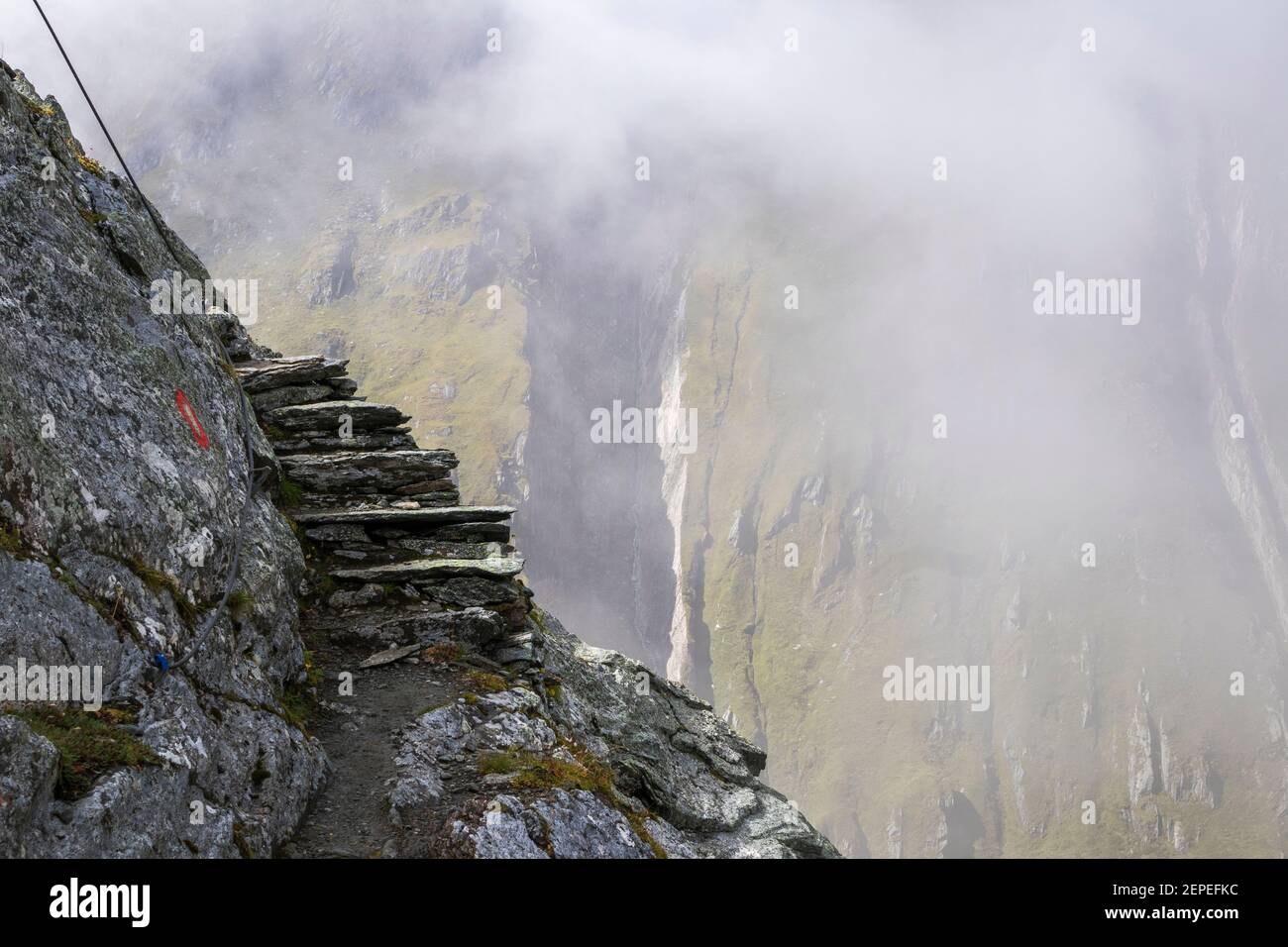 Stepped path on mountain rock. Venediger Höhenweg trail. Timmeltal alpine valley. Austrian Alps. Europe. Stock Photo