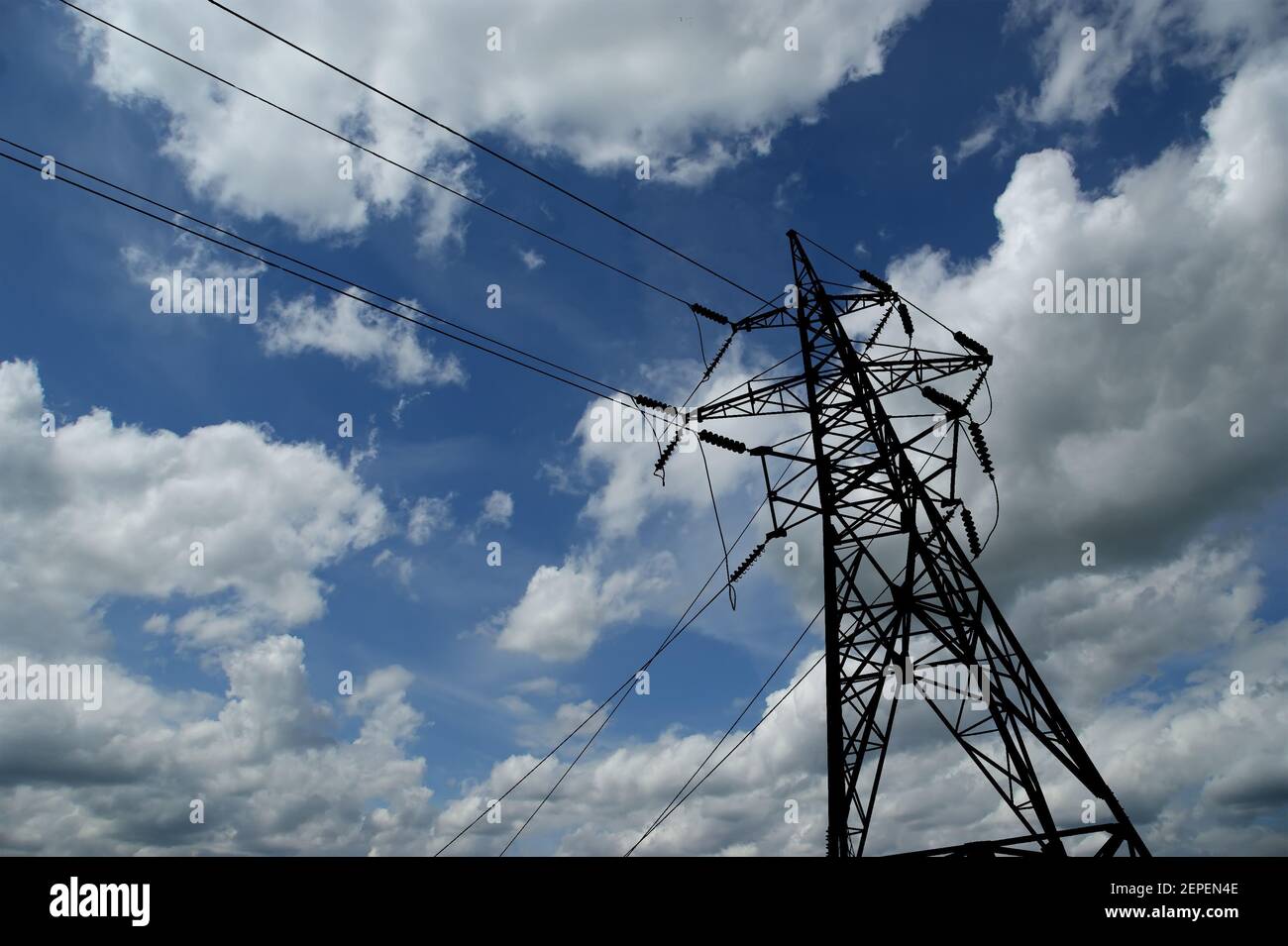 Electricity pylons and line against the blue sky and clouds Stock Photo ...