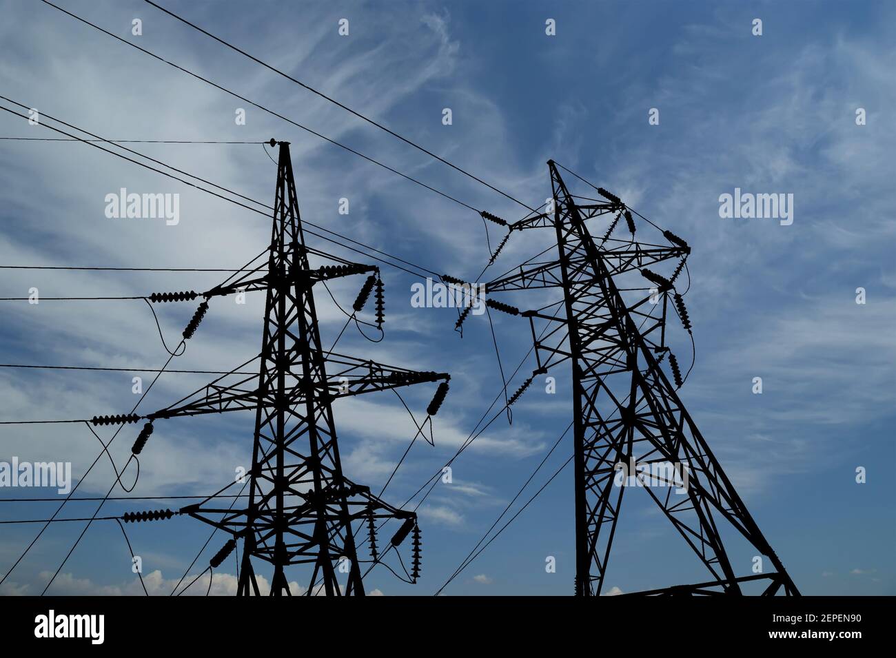 Electricity pylons and line against the blue sky and clouds Stock Photo ...