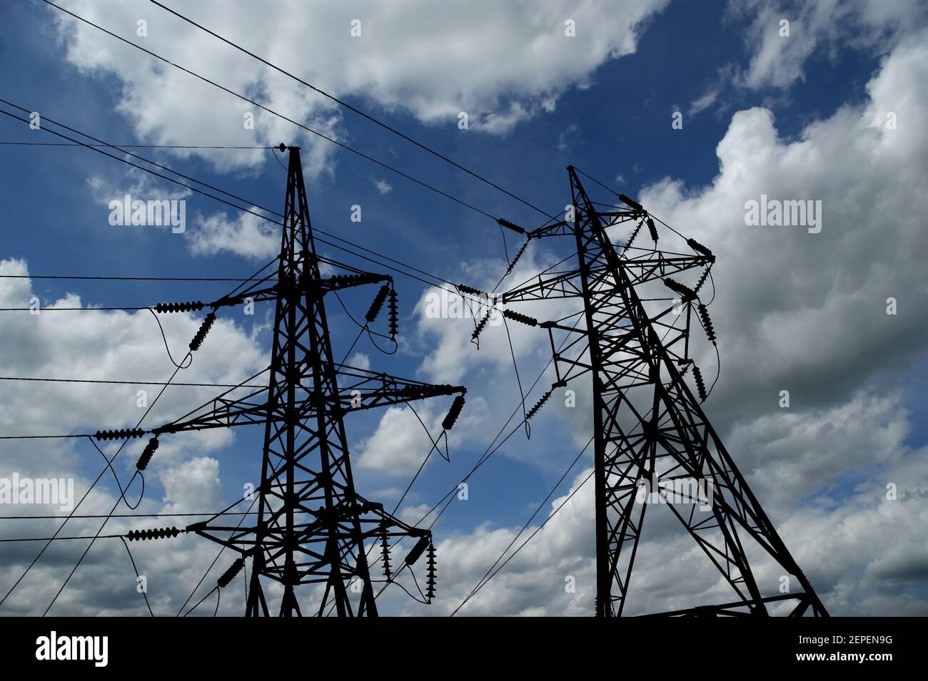 Electricity pylons and line against the blue sky and clouds Stock Photo ...