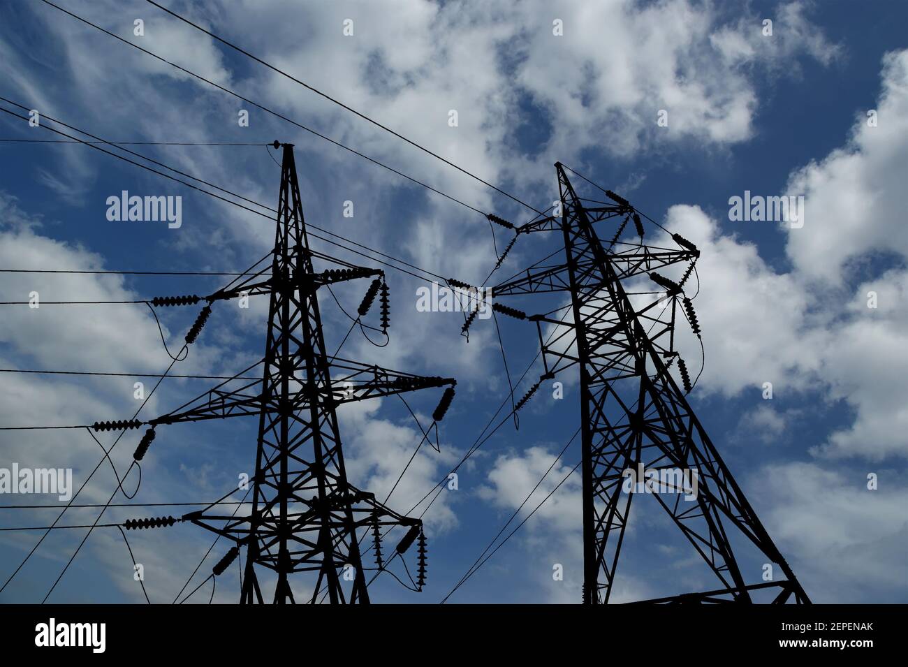 Electricity pylons and line against the blue sky and clouds Stock Photo ...