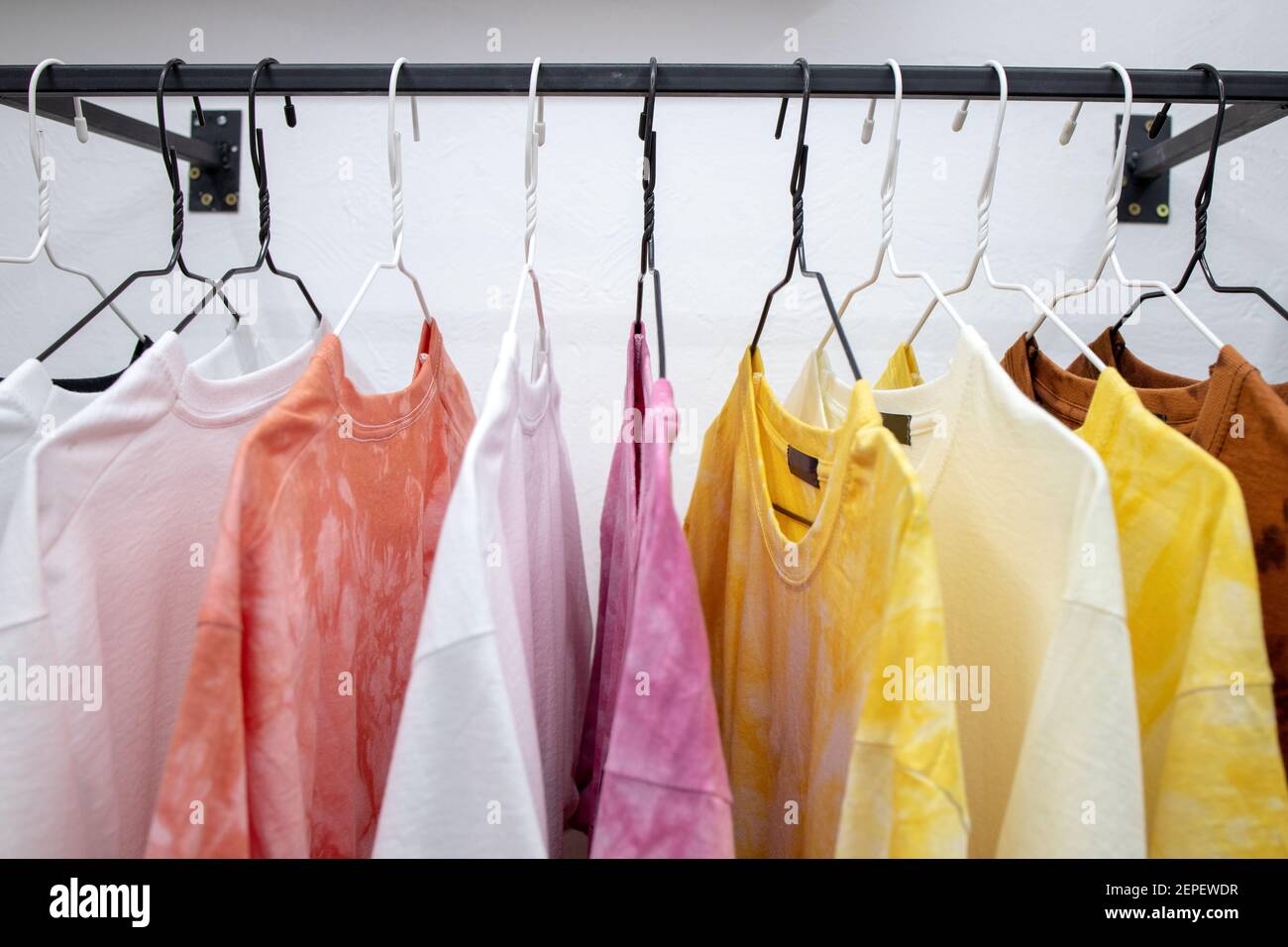 https://c8.alamy.com/comp/2EPEWDR/fashion-casual-t-shirts-hanging-at-store-place-colorful-choice-for-buy-clothes-2EPEWDR.jpg