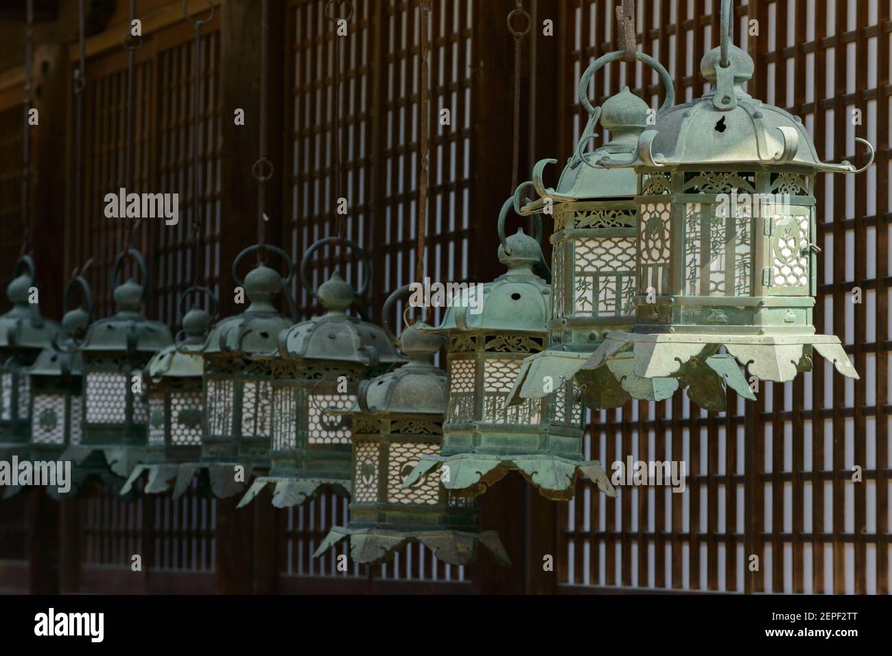A line of bronze lanterns in the Kasuga Shrine, Nara, Japan Stock Photo