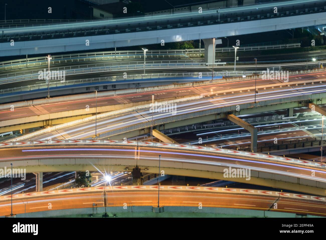 Layers of highway roads and train lines illuminated at night in Tokyo, Japan. Stock Photo