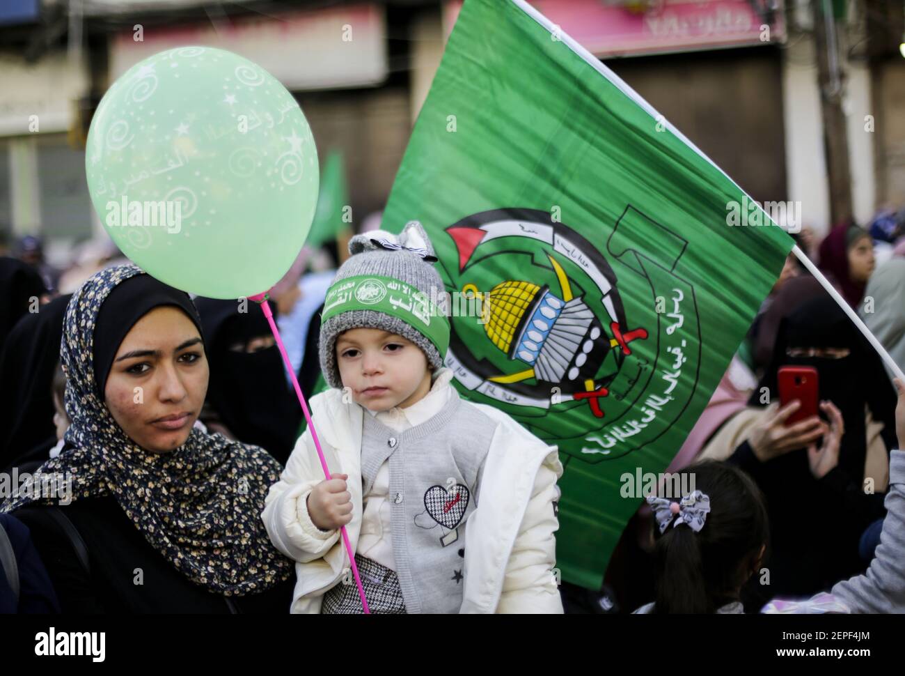 A kid with a Hamas headband while holding a balloon during a rally marking the 32nd anniversary of the founding of the Islamist movement Hamas. (Photo by Mahmoud Issa / SOPA Images/Sipa USA) Stock Photo