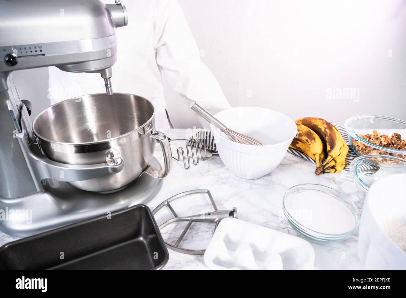 Mixing ingredients in kitchen mixer to bake banana nut bread Stock