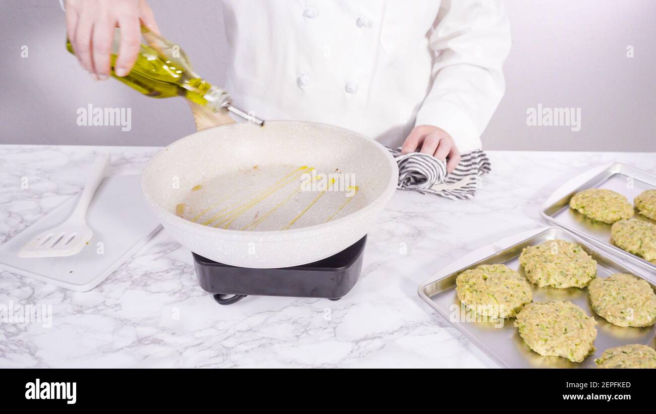 Step by step. Drizzling olive oil into the small frying pan to fry