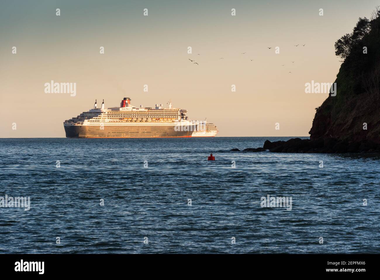 Queen Mary 2 Liner of the Cunard Line at anchor off the coast of Devon during the CV19 pandemic. Stock Photo