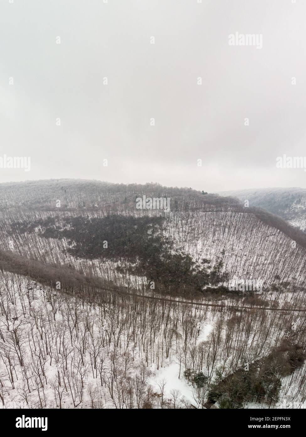 low ceiling of clouds scrape along the top of the ridges Stock Photo