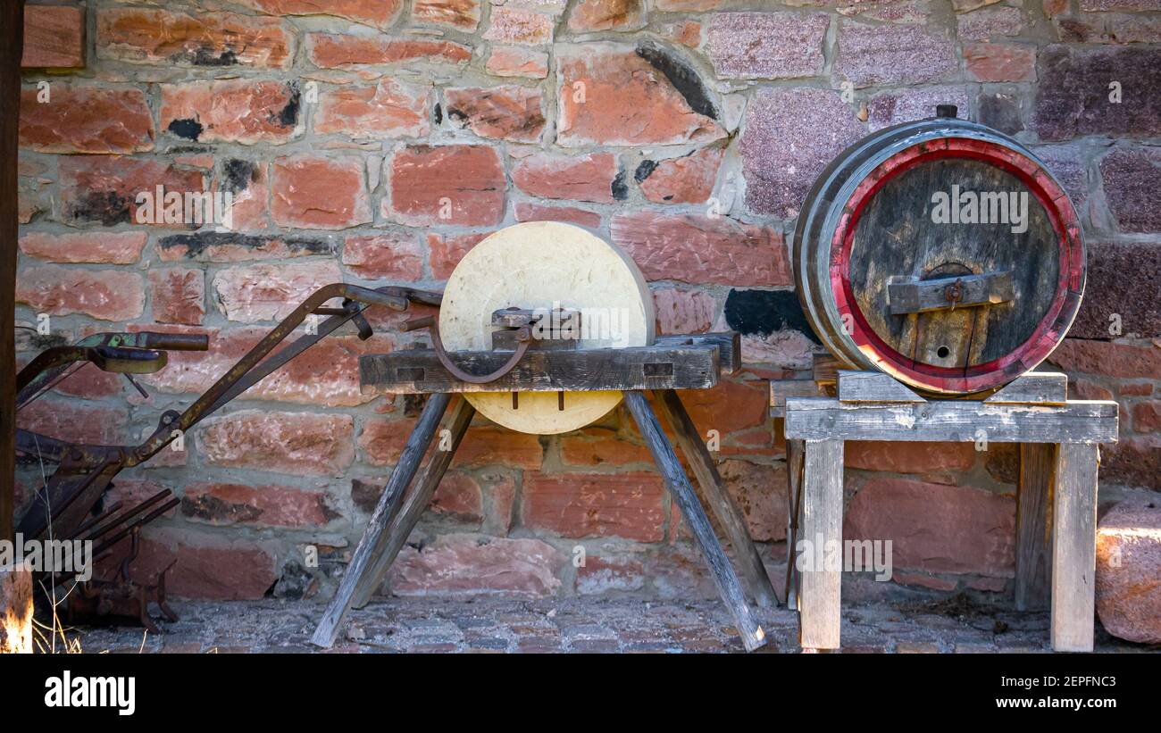 Ancient tools and wine cask of stone wall background. Country rural ...