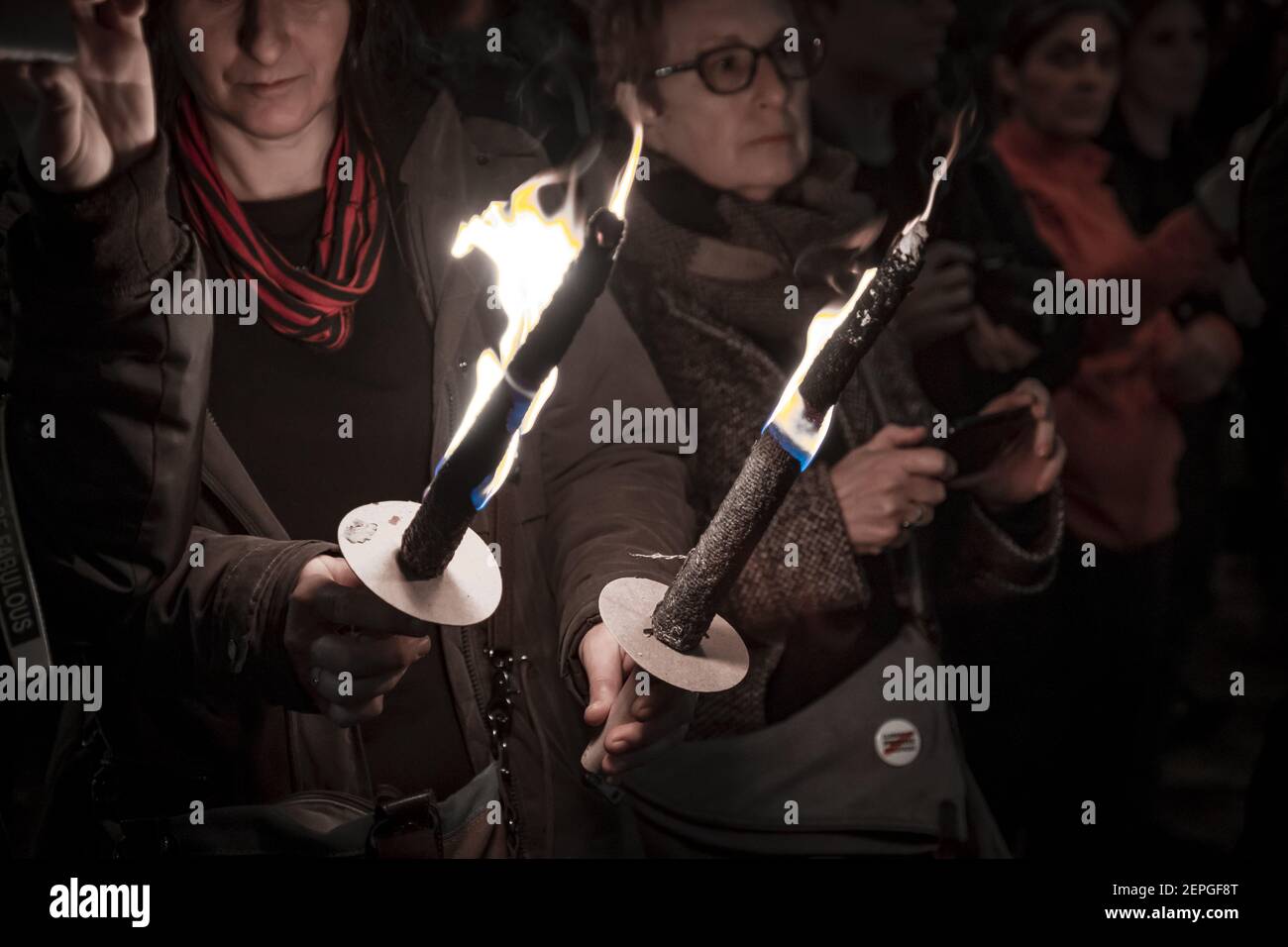 Protesters hold burning torches during the demonstration. Hundreds of