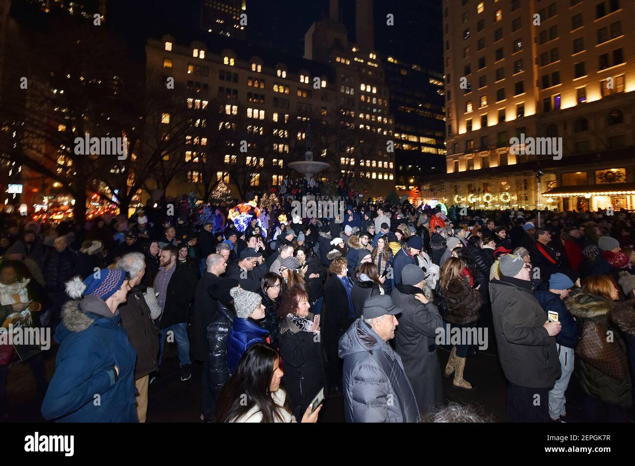 A large crowd is gathered along Grand Army Plaza to watch the world’s