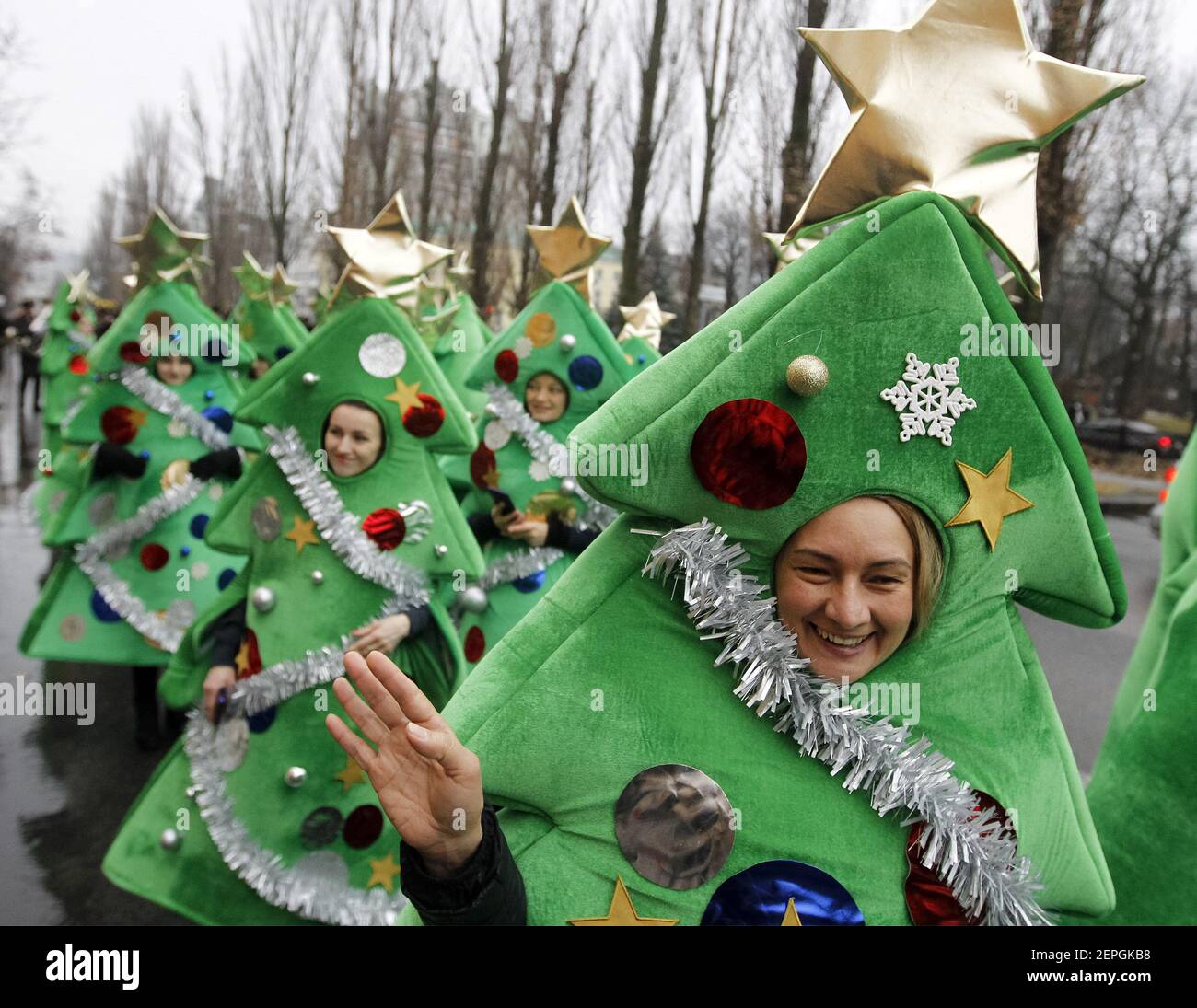Participant in a Christmas tree costume during the parade. Some five  hundred participants dressed in various Christmas costumes passed through  the center of Ukrainian capital with live music and fireworks. Costume  parades